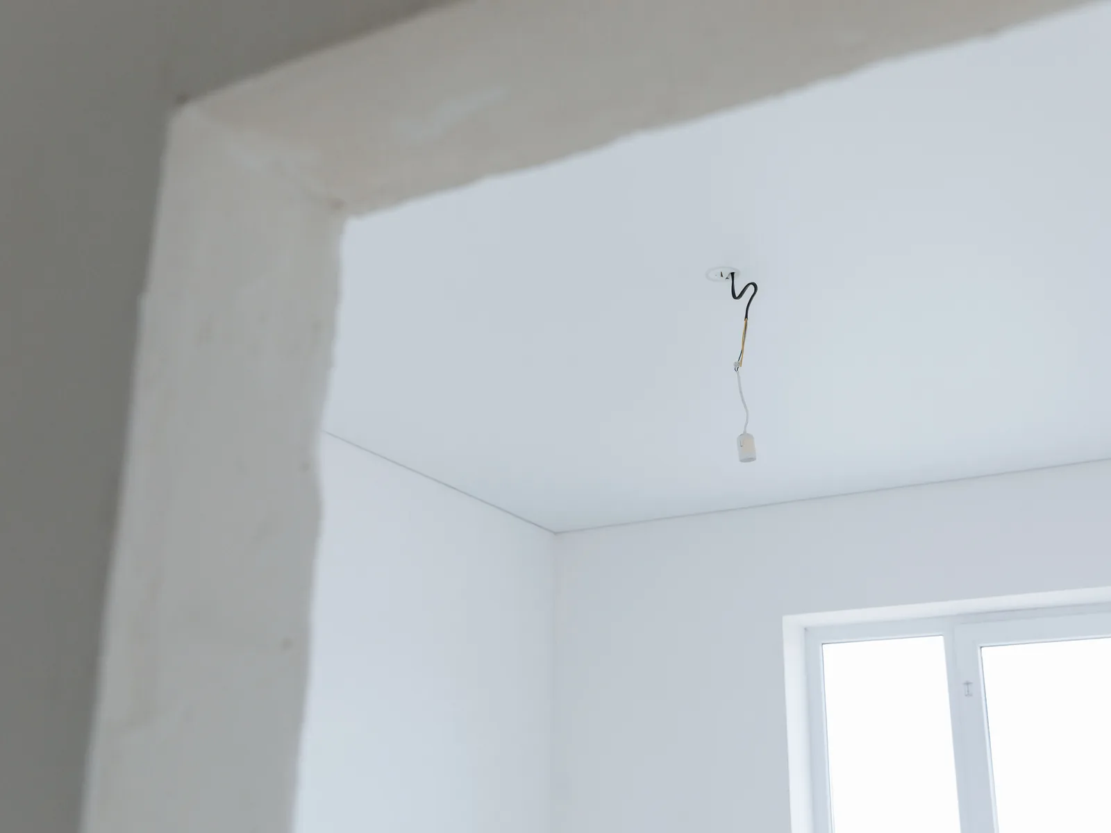 A smooth white corner beside a window opening